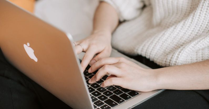 Smart Investments - Crop woman typing on laptop on bed