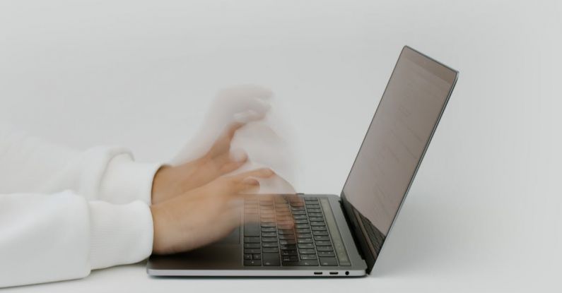 Cybersecurity Measures - Hands Typing on a Laptop Keyboard