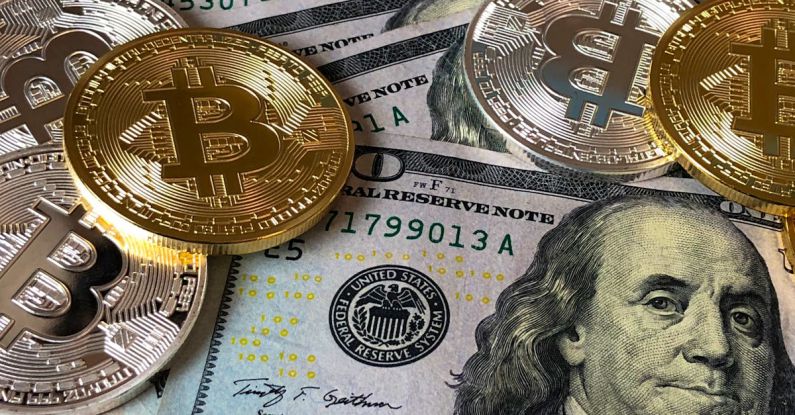 Economy - Bitcoins and U.s Dollar Bills